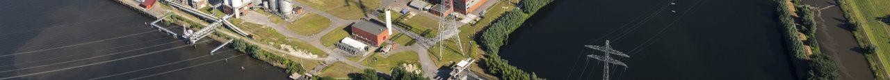 19 July 2016, Geertruidenberg, Holland. Aerial view of the AMERCENTRALE, a coal and biomass fired Essent powerplant. It's located at the river Amer. In the back the town of GEERTRUIDENBERG. 