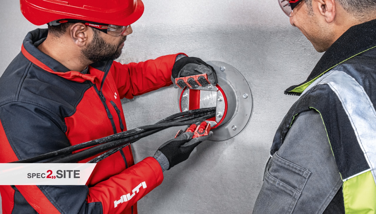 a Hilti field engineer demonstrates to a customer a firestopping sleeve in an electrical application